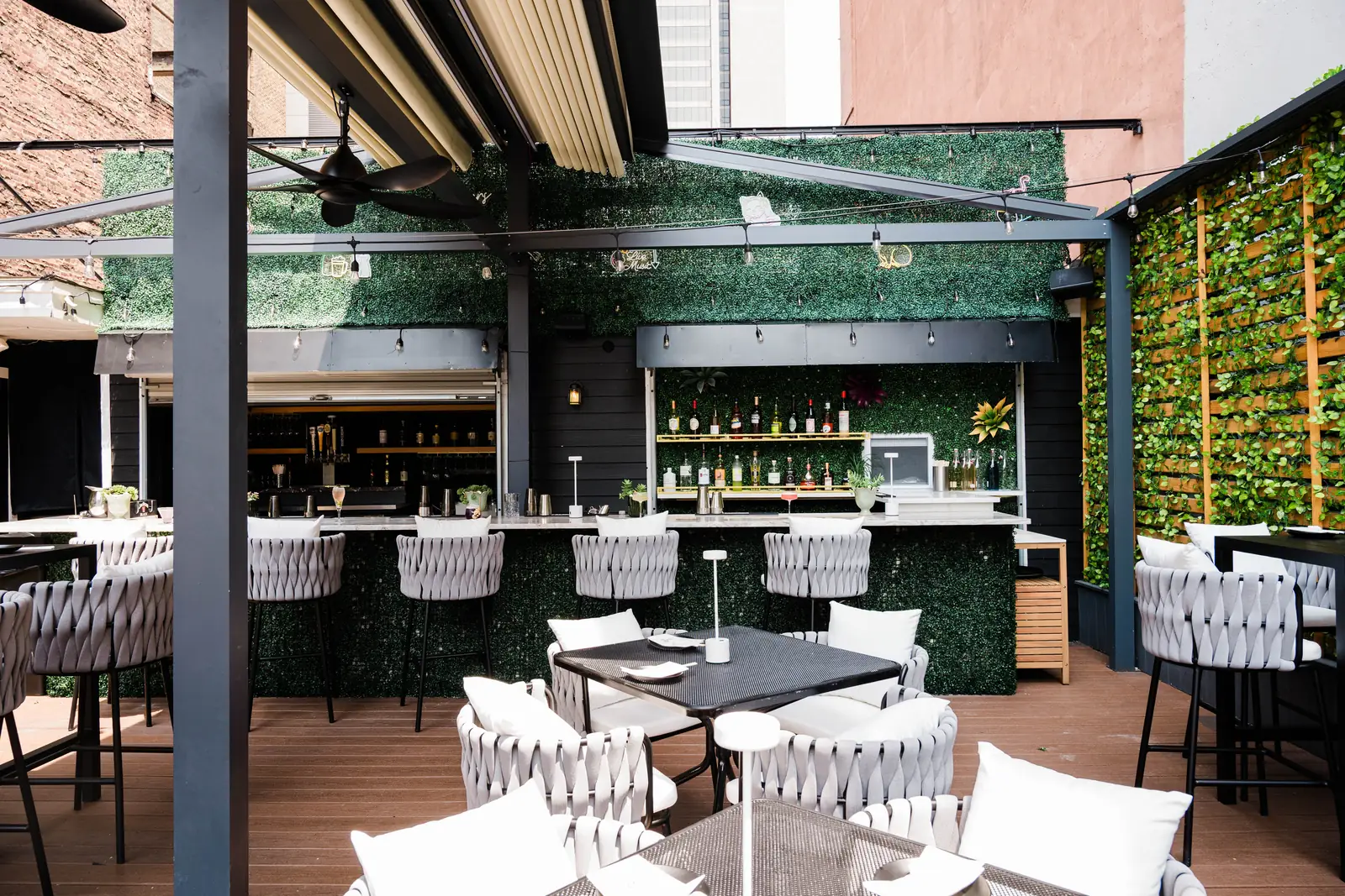 The rooftop bar with its neon signs and string lights