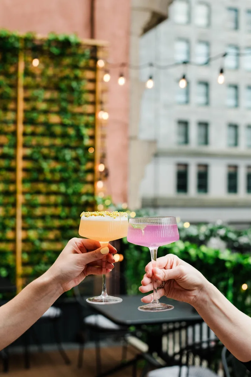 A cocktail cheers above downtown Pittsburgh