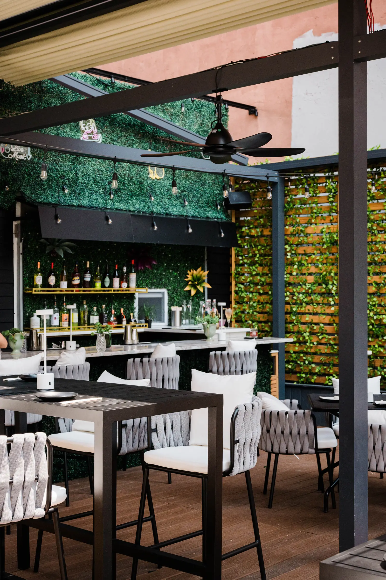 Tables set beneath the ceiling fans on the rooftop