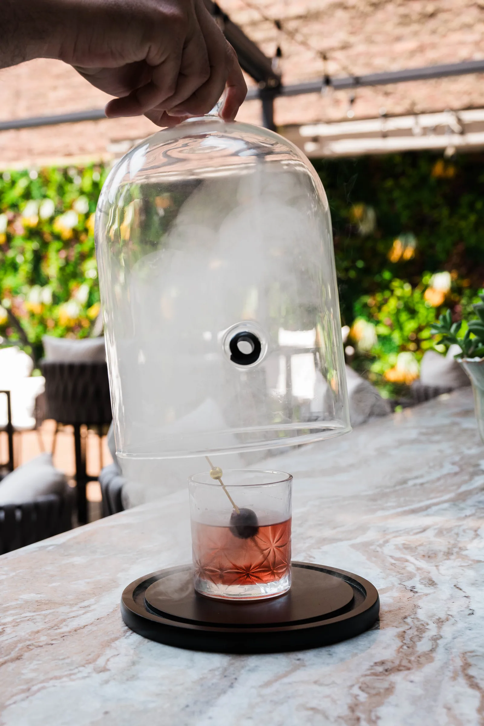 A smoked cocktail under the glass cloche