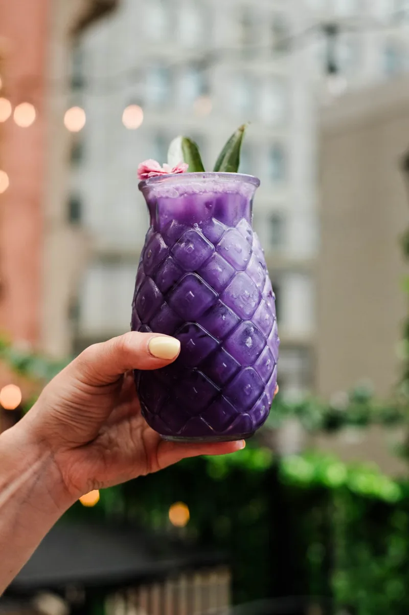 The purple pineapple, downtown skyline behind