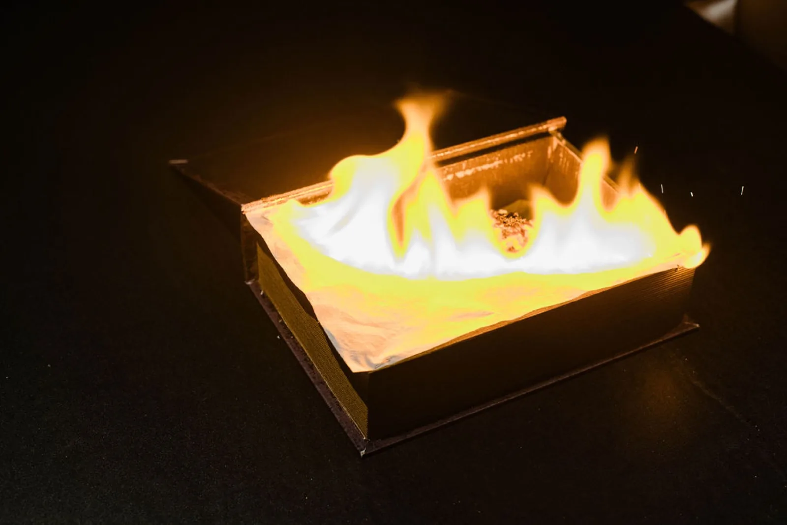 The flaming presentation box at the Okane Omakase counter